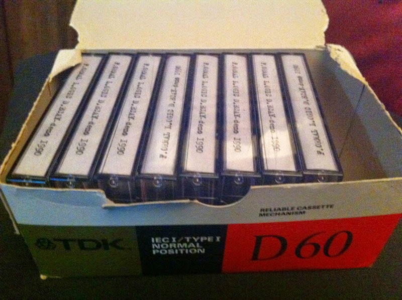 image which shows an old cardboard box containing some copies of first F.ormal L.ogic D.ecay demo tape